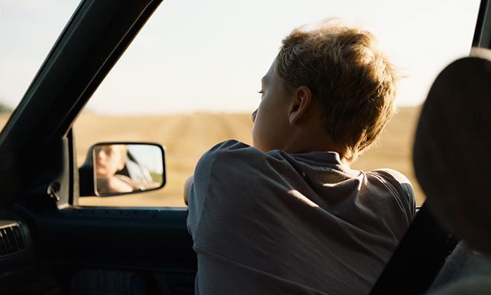 Close - Leo looking at the car window into the rearview mirror