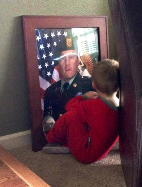 Little boy looking at his veteran father