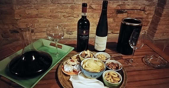 Brunello wine and snack tray at Casa Bolsinina in Tuscany, Italy